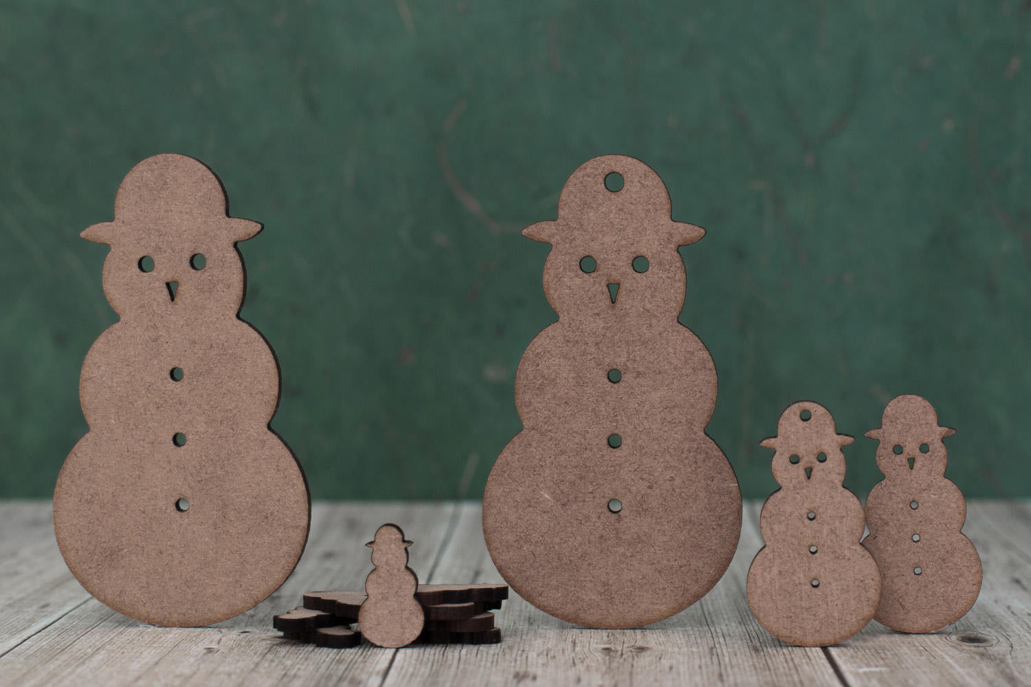 Group of laser cut snowman shapes of various sizes